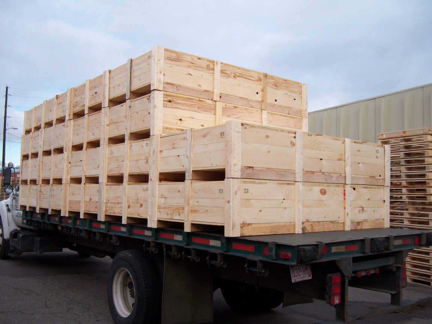 A truck with wooden crates on the back of it.