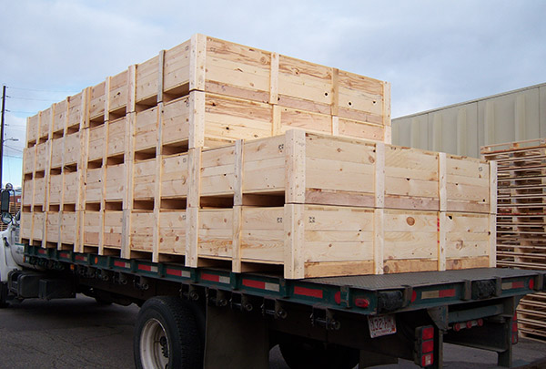 A truck with wooden crates on the back of it.