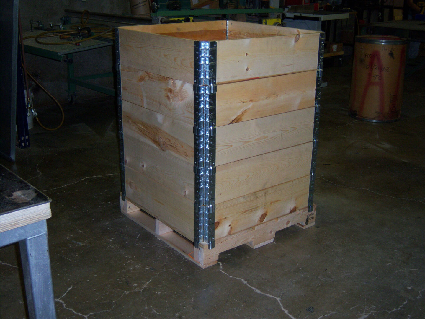 A wooden crate with metal straps around it.