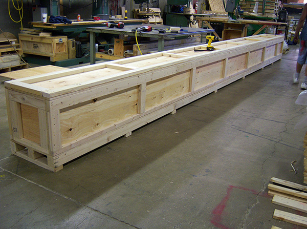 A large wooden box sitting in the middle of a room.