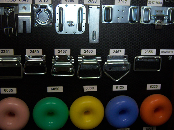 A wall of different colored donuts and metal handles.